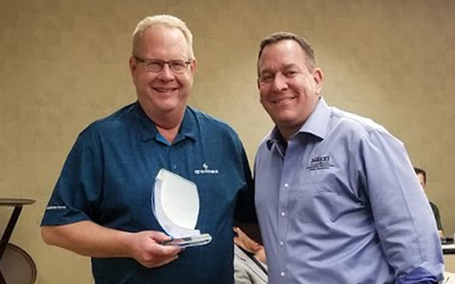 Loran Knudsvig (left) accepts award from Adam Stolberg (right), Executive Director of SWPA (Submersible Wastewater Pump Association)